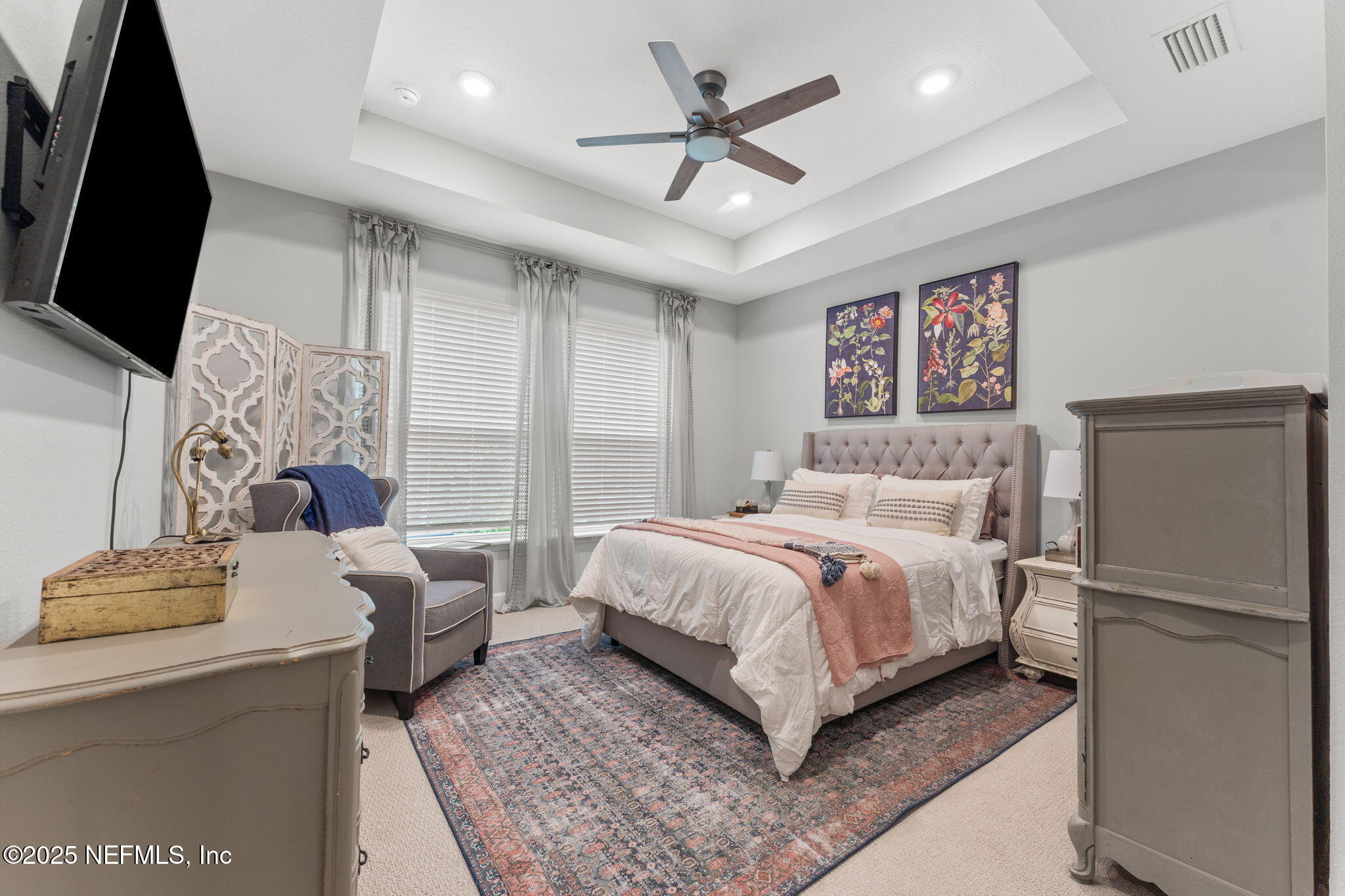 267 Windswept Way St. Augustine, FL 32092 - Photo 19 of 50 a bedroom with a bed flat screen tv and a couch