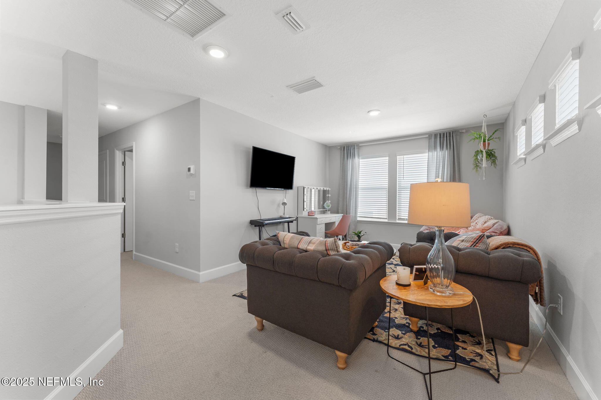 267 Windswept Way St. Augustine, FL 32092 - Photo 25 of 50 a living room with furniture and a flat screen tv