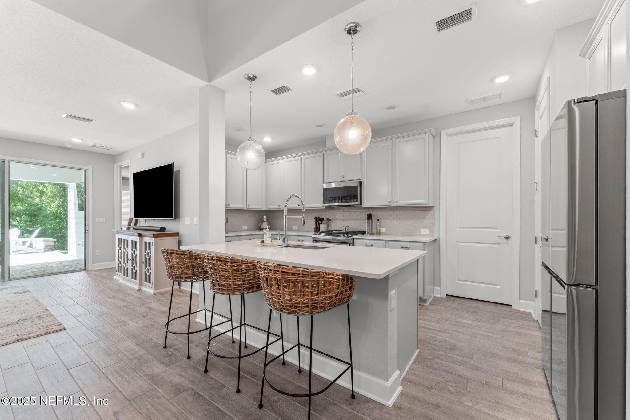 267 Windswept Way St. Augustine, FL 32092 - Photo 6 of 50 a view of a kitchen with kitchen island granite countertop a sink and a stove top oven with wooden floor