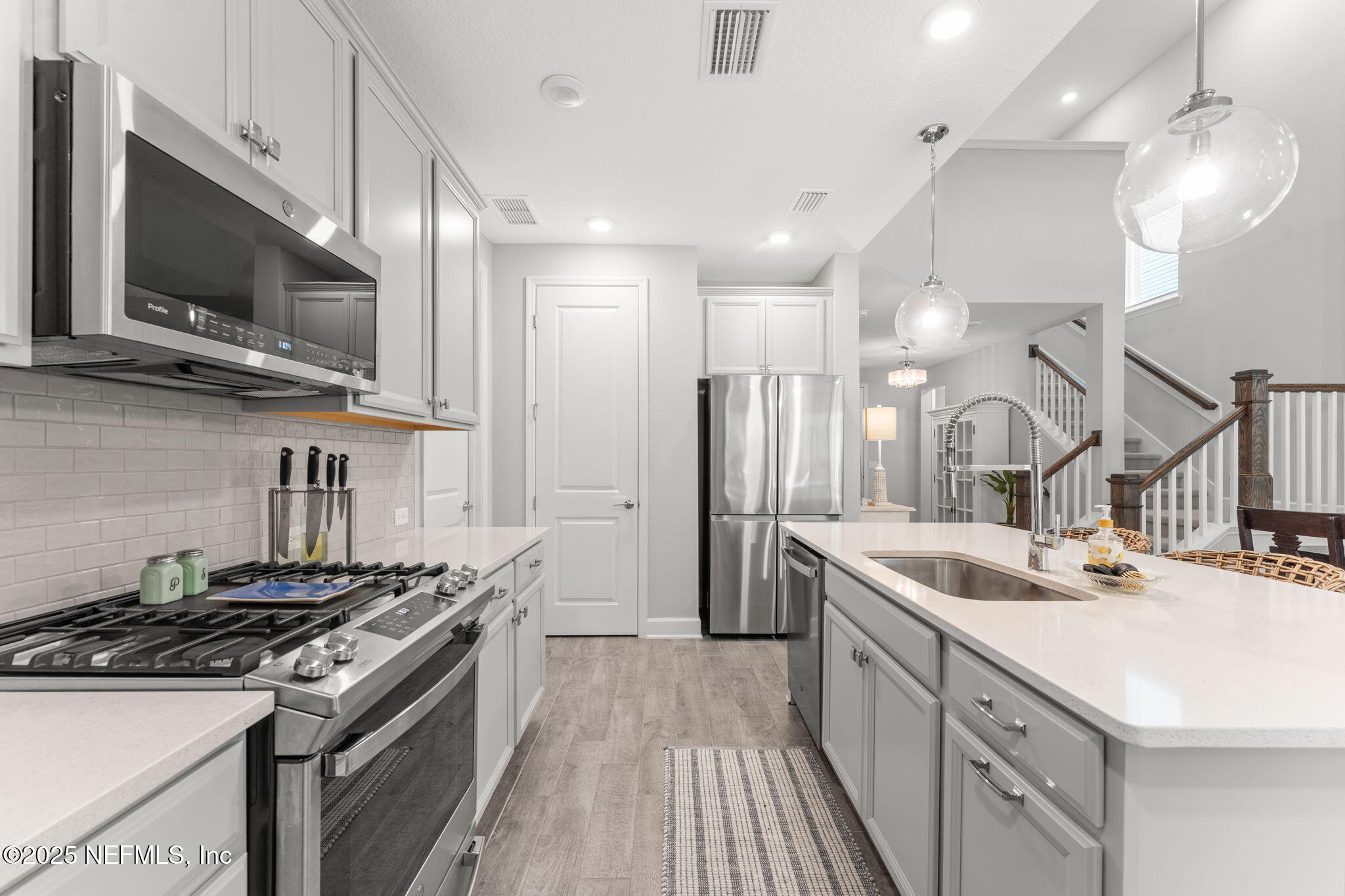 267 Windswept Way St. Augustine, FL 32092 - Photo 7 of 50 a kitchen with stainless steel appliances a sink stove and refrigerator