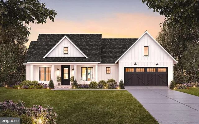 a front view of a house with a garden and yard