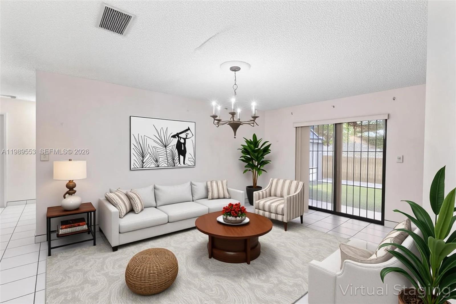 4210 Southwest 134th Avenue Miami, FL 33175 - Photo 14 of 32 a living room with furniture and a chandelier
