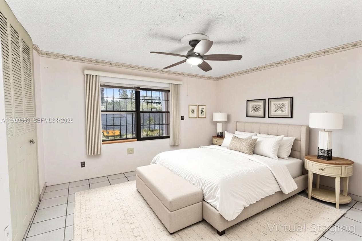 4210 Southwest 134th Avenue Miami, FL 33175 - Photo 16 of 32 a spacious bedroom with a large bed and a window