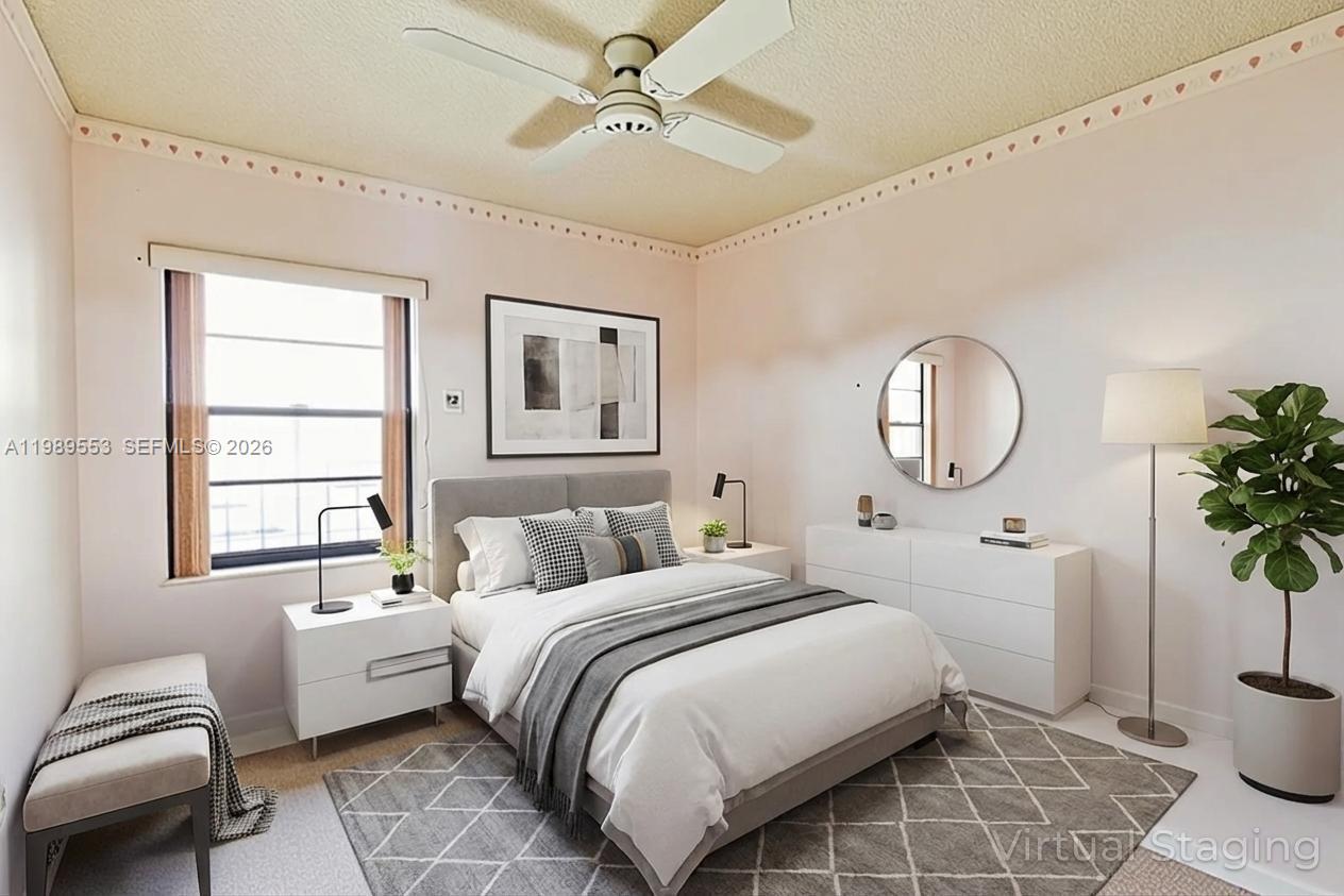 4210 Southwest 134th Avenue Miami, FL 33175 - Photo 18 of 32 a bedroom with a large bed and a chandelier