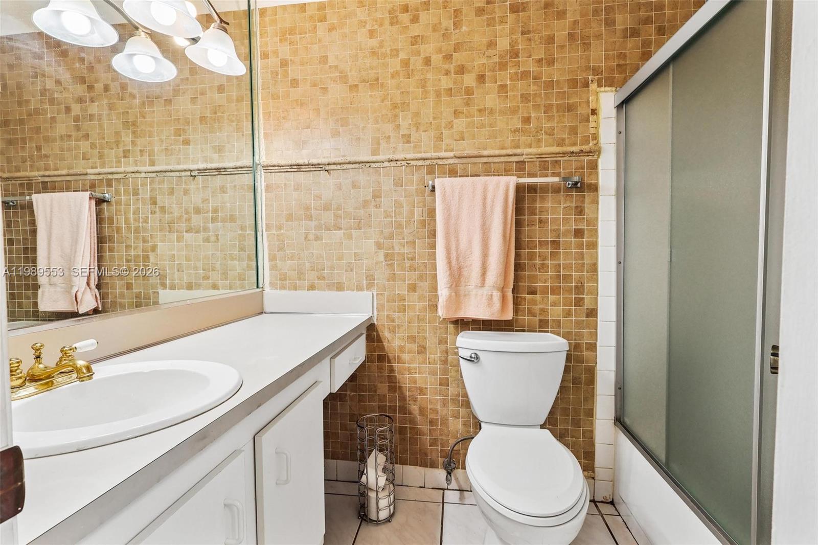 4210 Southwest 134th Avenue Miami, FL 33175 - Photo 20 of 32 a bathroom with a sink a toilet a mirror and shower
