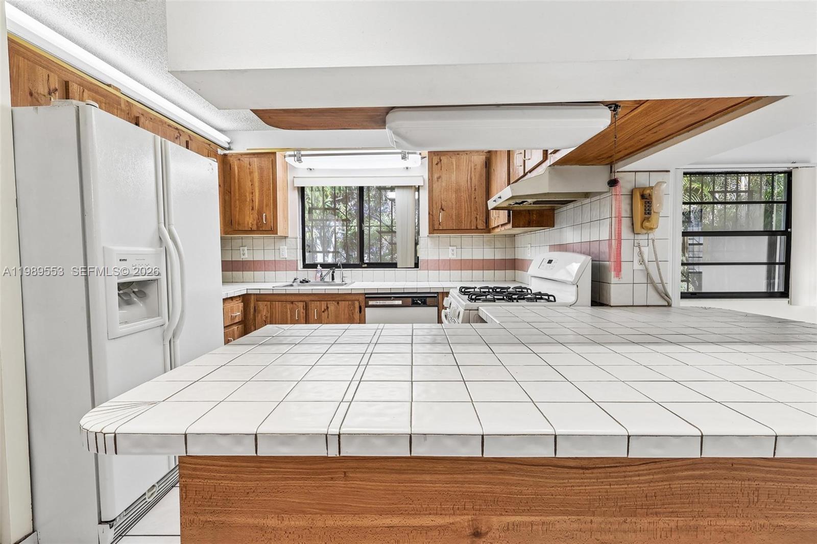 4210 Southwest 134th Avenue Miami, FL 33175 - Photo 10 of 32 a kitchen with a sink cabinets and appliances