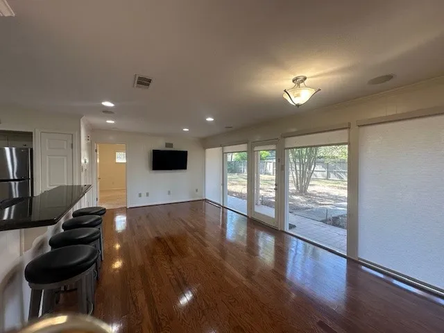 a view of an entryway with wooden floor