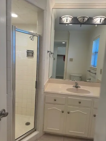 a bathroom with a sink a mirror and a shower