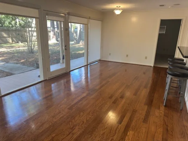 a view of room with wooden floor and glass door