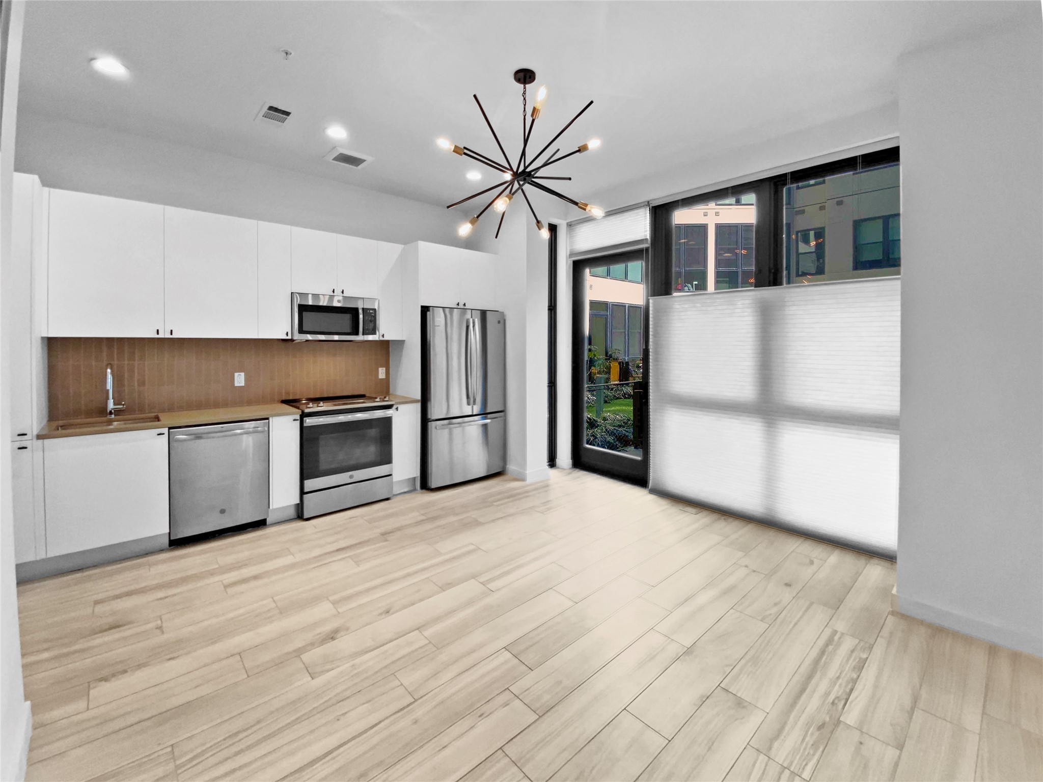 800 Embassy Drive, Unit 123 Austin, TX 78702 - Photo 1 of 39 a view of a kitchen with a sink and a refrigerator