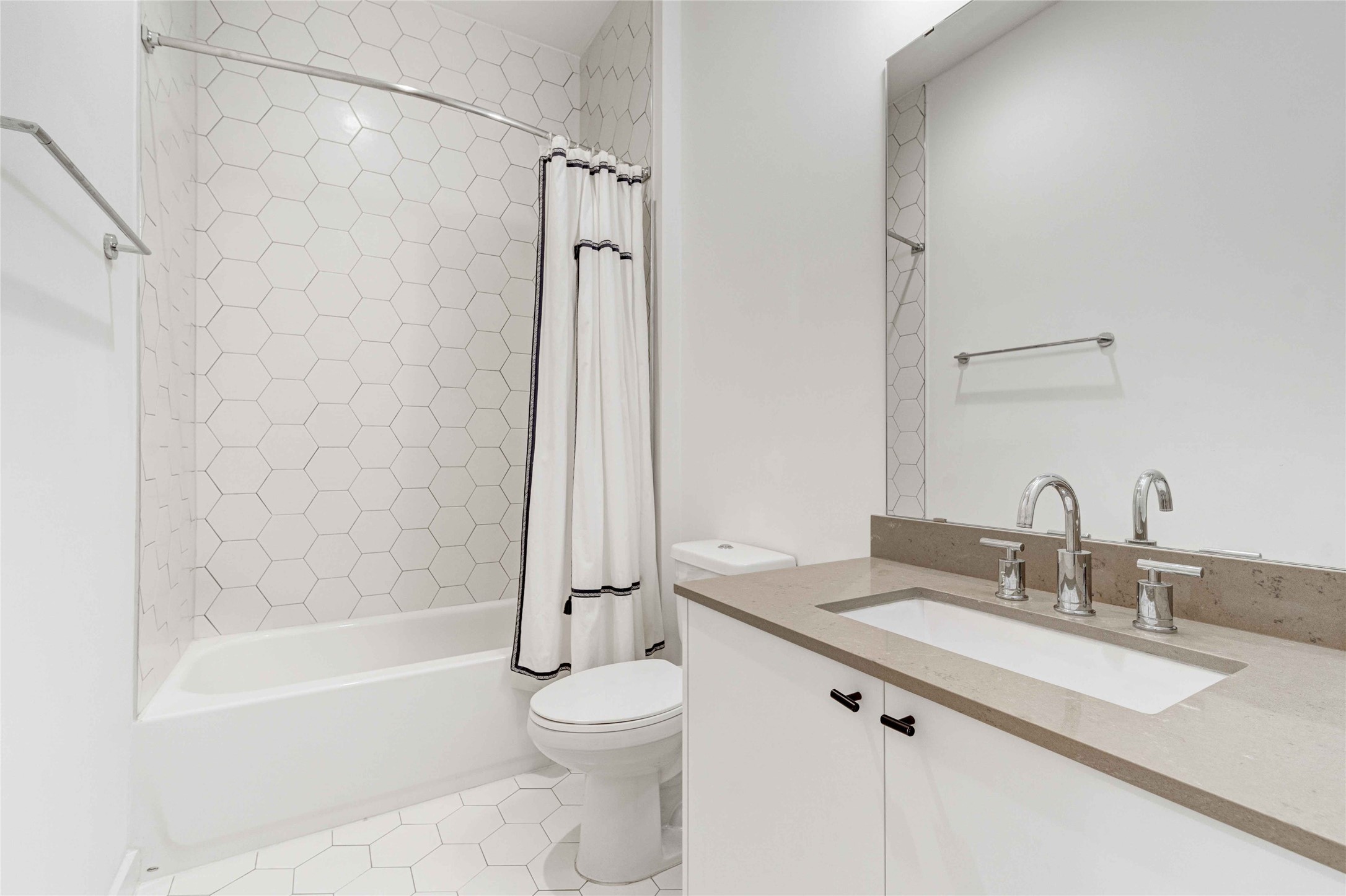 800 Embassy Drive, Unit 123 Austin, TX 78702 - Photo 11 of 39 a bathroom with a granite countertop sink a toilet and shower