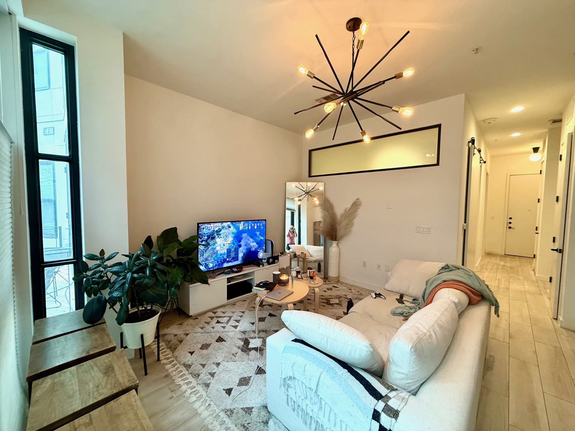 800 Embassy Drive, Unit 123 Austin, TX 78702 - Photo 33 of 39 a living room with furniture and a chandelier