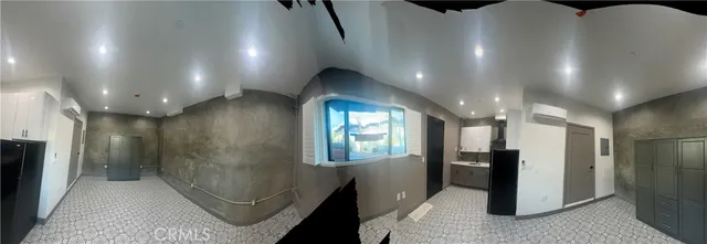 a view of hallway with stairs and wooden floor