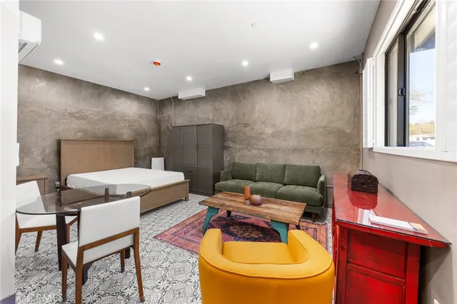 a reading room with furniture a rug and a toilet