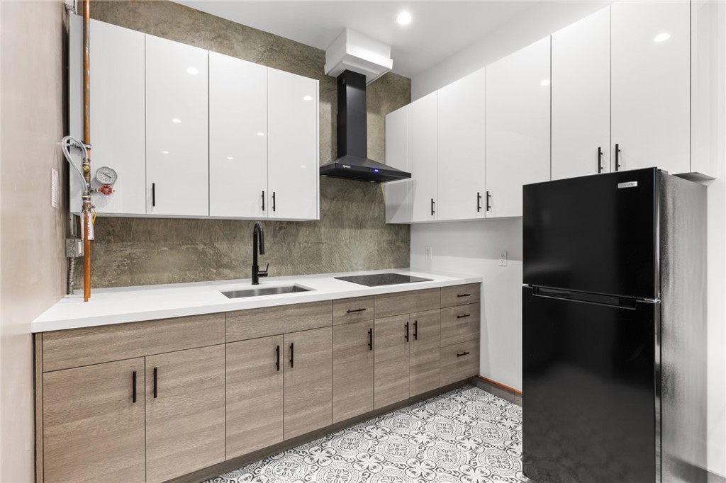 2211-1.2 Hyperion Avenue, Unit 1/2 Los Angeles, CA 90027 - Photo 8 of 15 a kitchen with stainless steel appliances granite countertop a refrigerator a sink and white cabinets