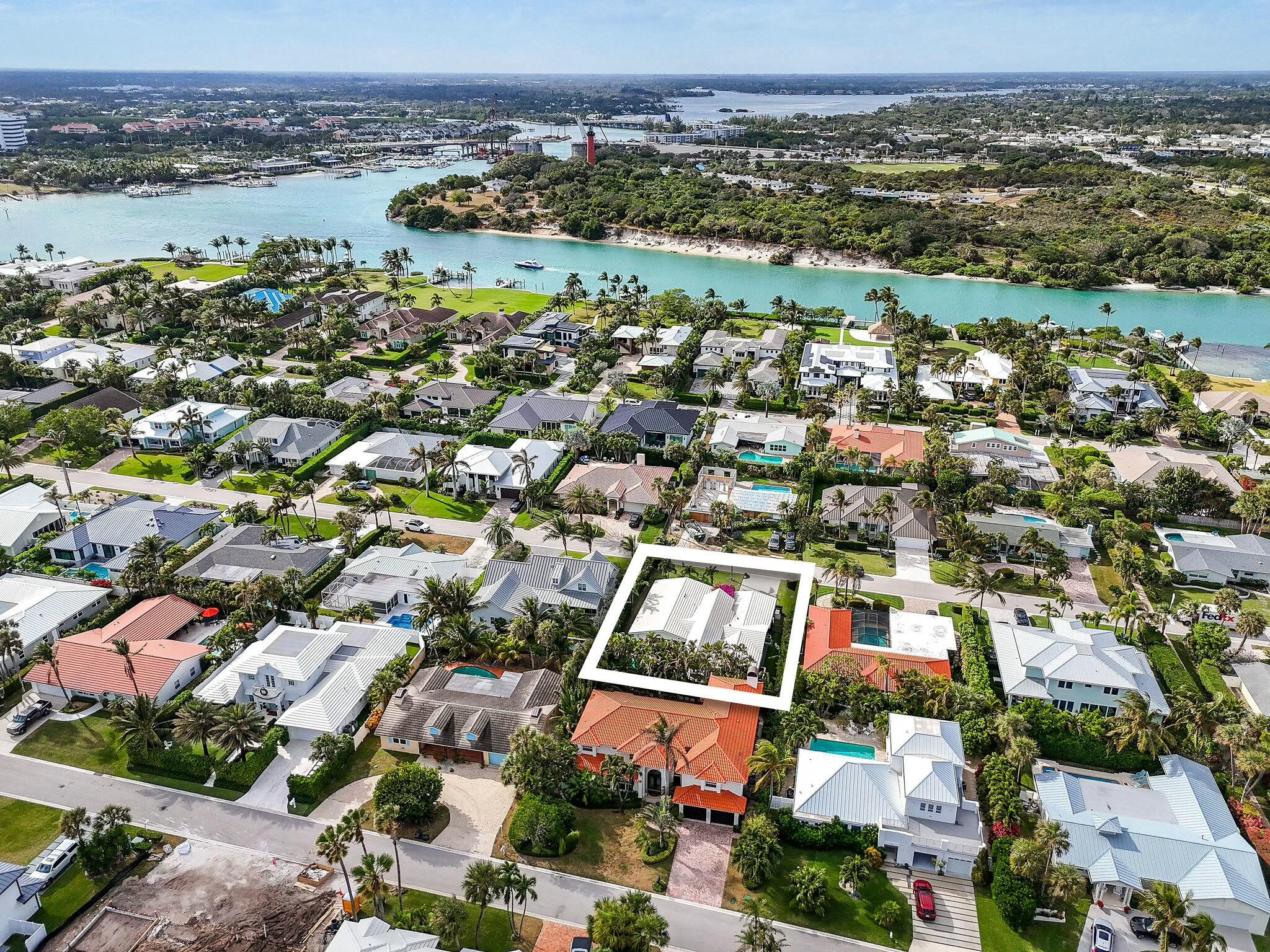 170 Beacon Lane Jupiter Inlet Colony, FL 33469 - Photo 32 of 46 an aerial view of a city with lots of residential buildings and mountain view in back