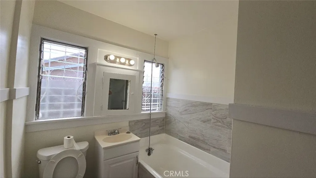 456 West 59th Place Los Angeles, CA 90003 - Photo 18 of 21 a bathroom with a sink a toilet and a bathtub