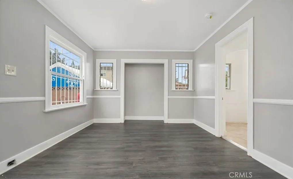 456 West 59th Place Los Angeles, CA 90003 - Photo 3 of 21 a view of an empty room with wooden floor and a window