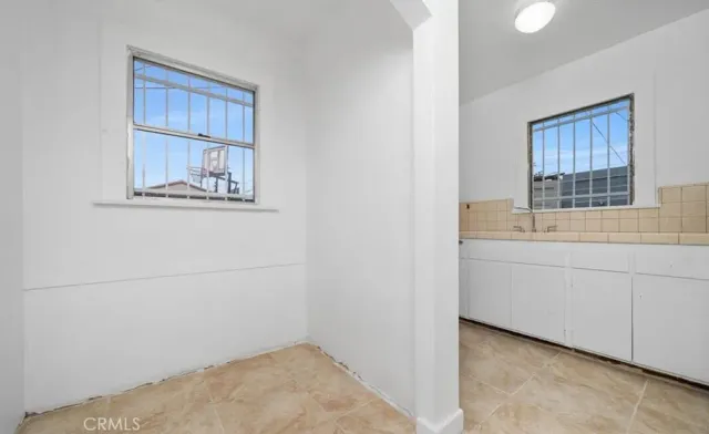 a room with a window and cabinet