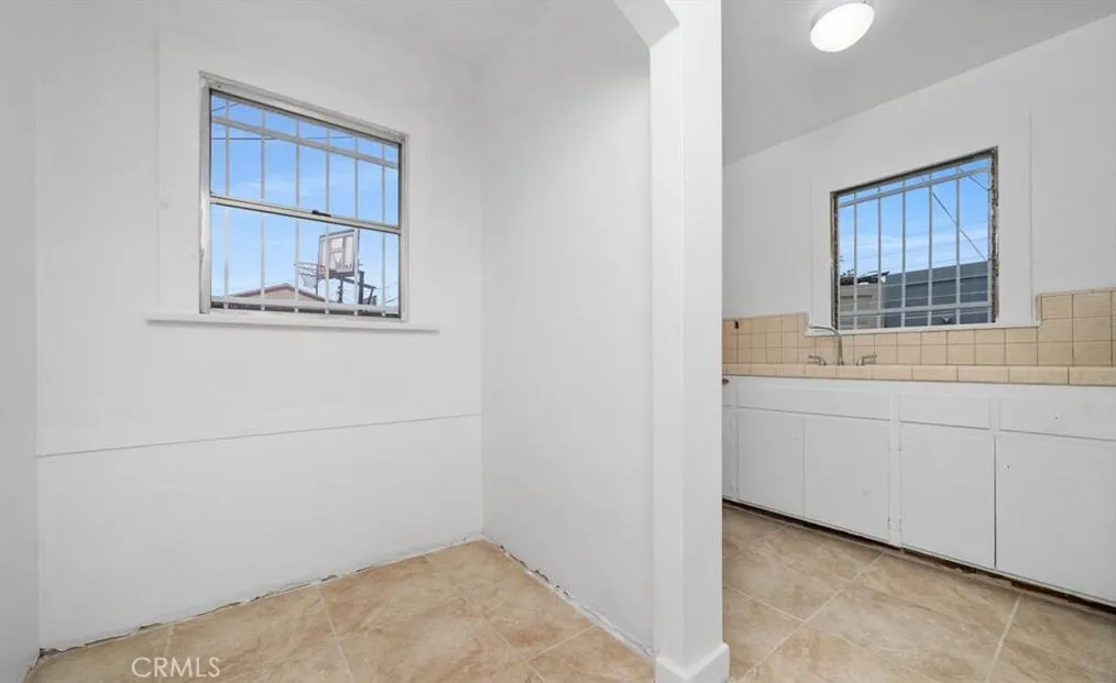 456 West 59th Place Los Angeles, CA 90003 - Photo 5 of 21 a room with a window and cabinet