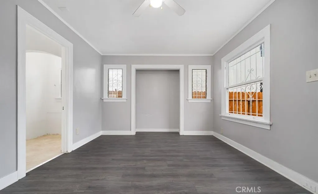 456 West 59th Place Los Angeles, CA 90003 - Photo 6 of 21 a view of an empty room with wooden floor and a window