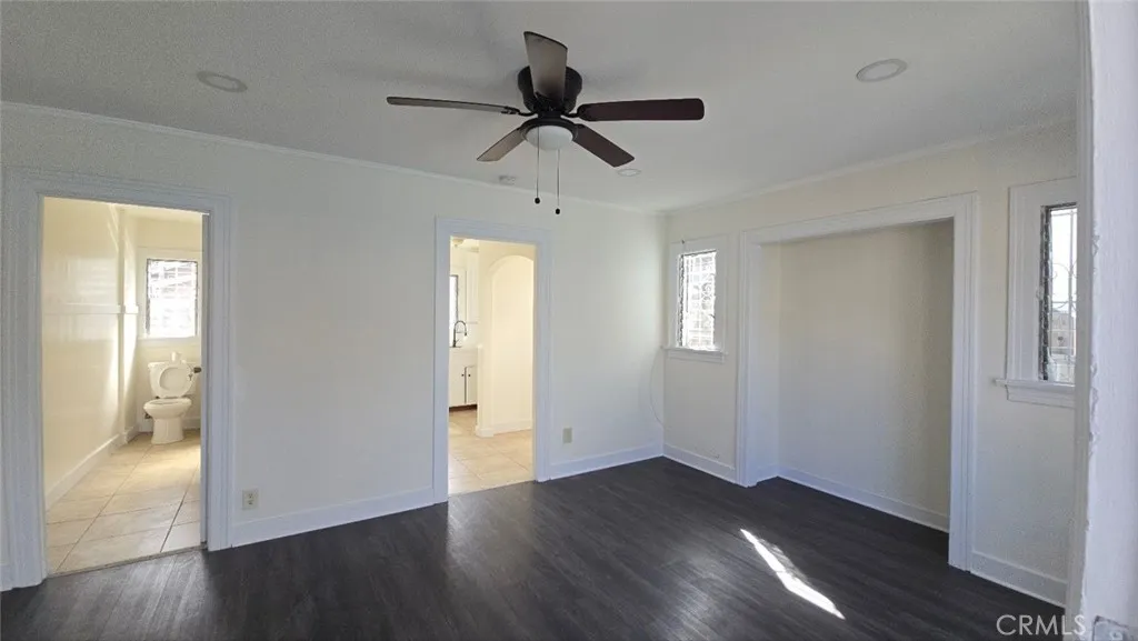456 West 59th Place Los Angeles, CA 90003 - Photo 8 of 21 a view of empty room with wooden floor and ceiling fan