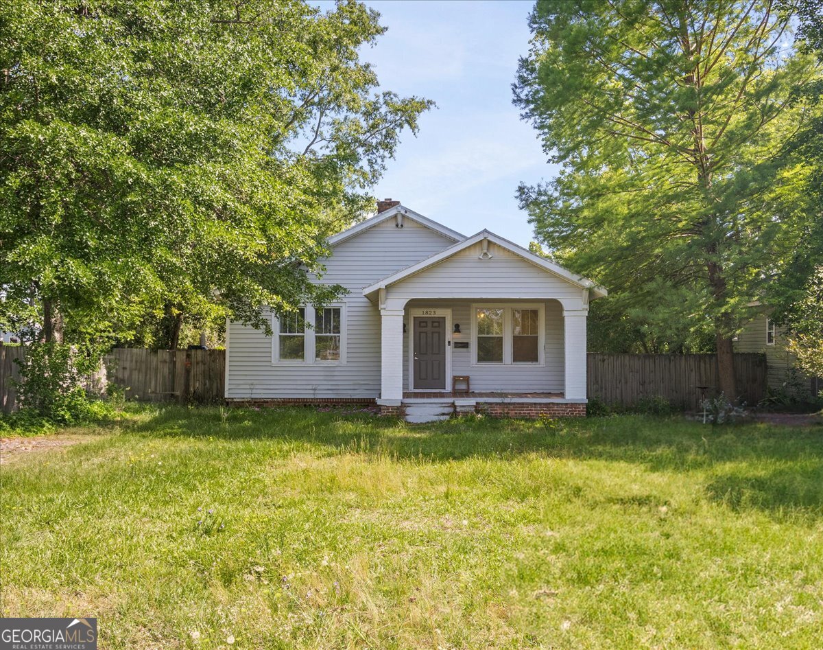 1823 Starnes Street Augusta, GA 30904 - Photo 1 of 34 a front view of a house with a yard and garage