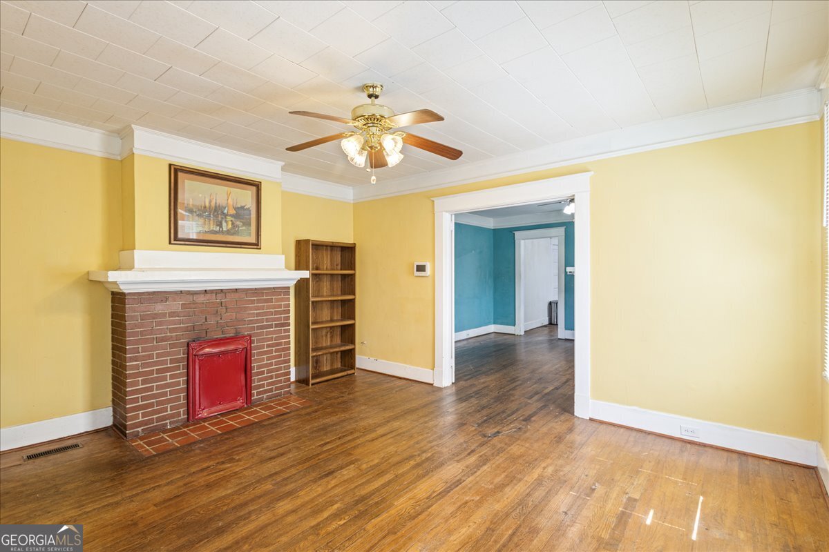 1823 Starnes Street Augusta, GA 30904 - Photo 13 of 34 a view of an empty room with wooden floor and a fireplace