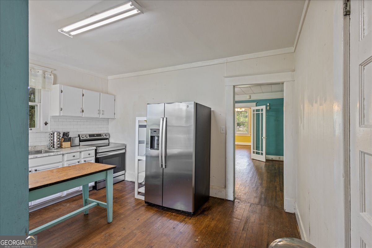 1823 Starnes Street Augusta, GA 30904 - Photo 17 of 34 a kitchen with stainless steel appliances a refrigerator and wooden floor