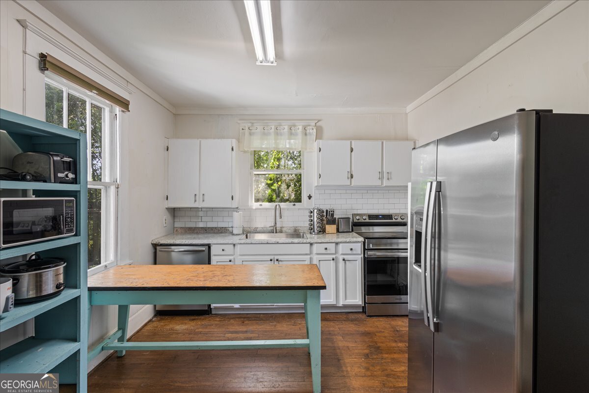 1823 Starnes Street Augusta, GA 30904 - Photo 18 of 34 a kitchen with kitchen island a counter top space stainless steel appliances and cabinets