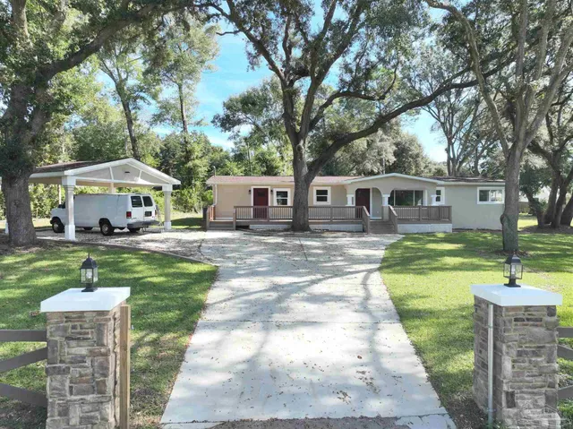 a patio with table and chairs under an umbrella
