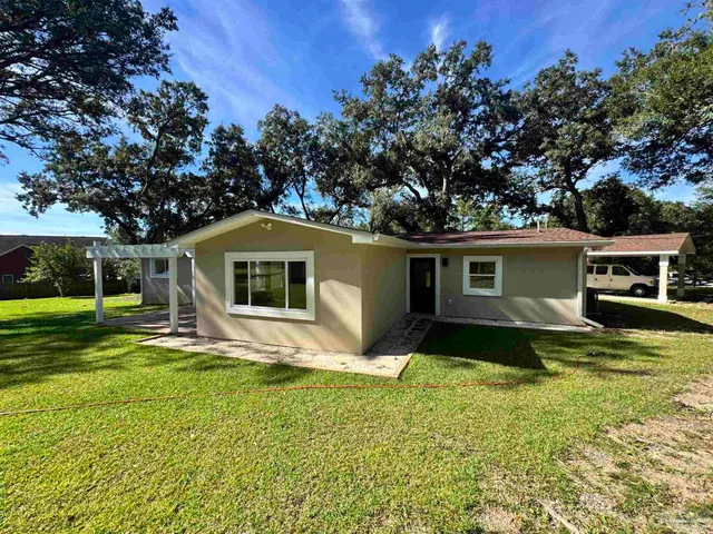 a house that has a tree in front of the house