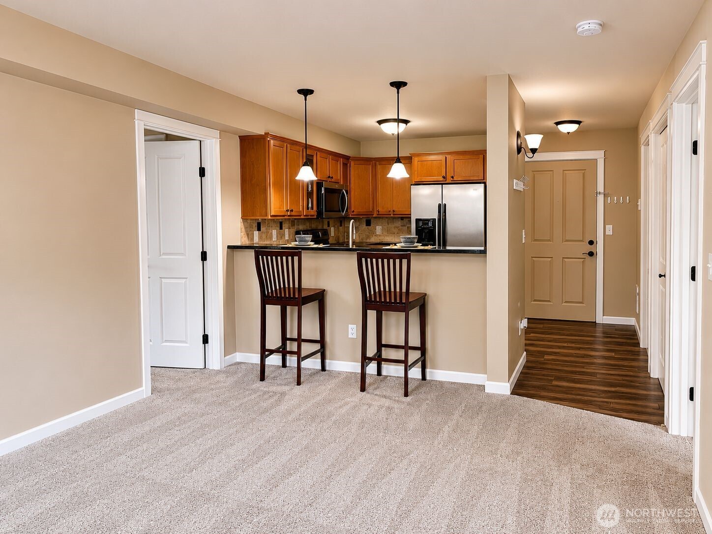 700 32nd Street, Unit A309 Bellingham, WA 98225 - Photo 7 of 28 a open kitchen with a table and chairs in it