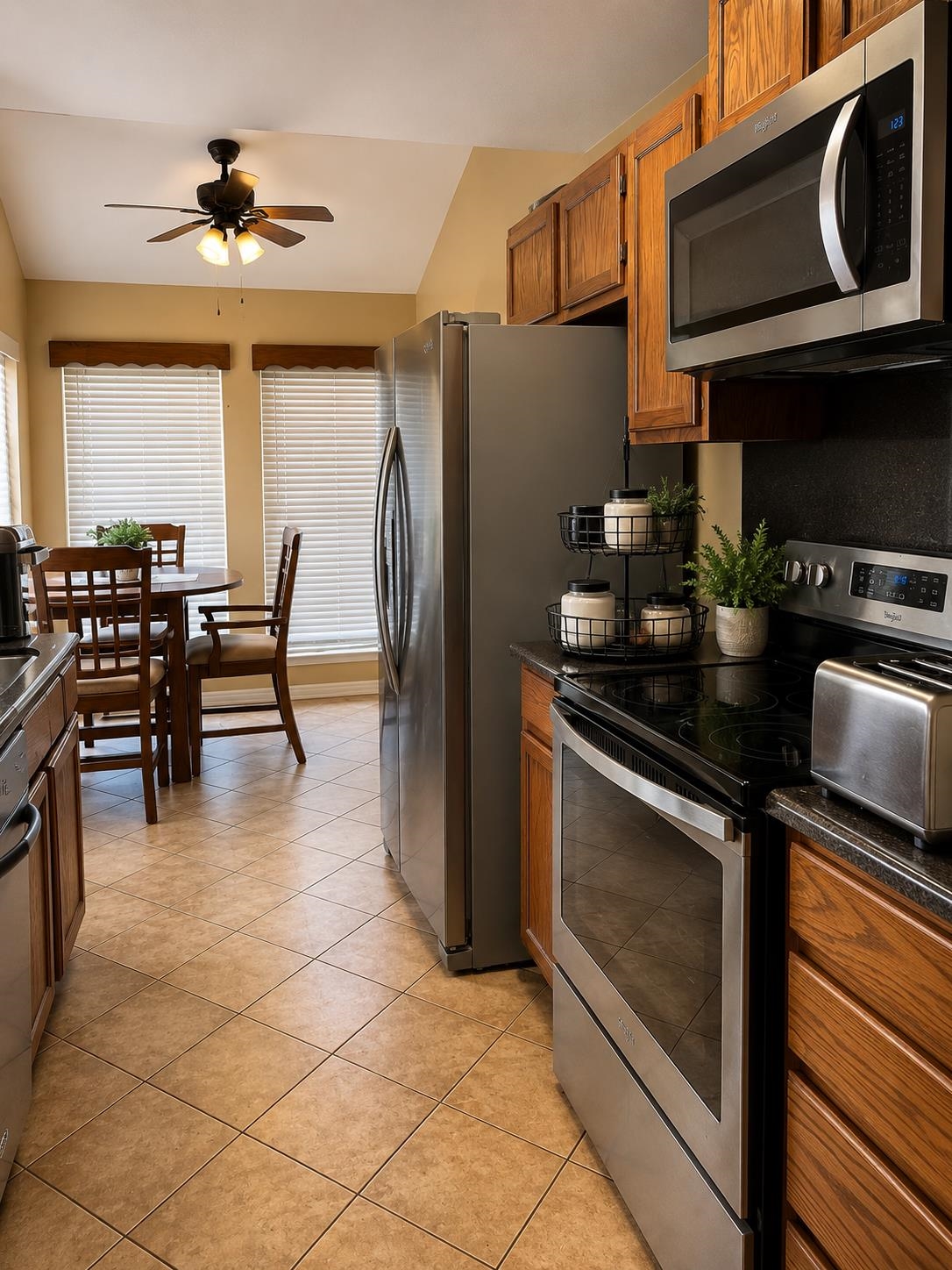 5845 Meadowview Road Beaumont, TX 77708 - Photo 5 of 24 a kitchen with stainless steel appliances granite countertop a stove refrigerator and a microwave