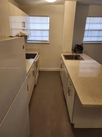 a kitchen with sink a microwave a stove and refrigerator