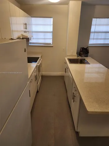 a kitchen with sink a microwave a stove and refrigerator