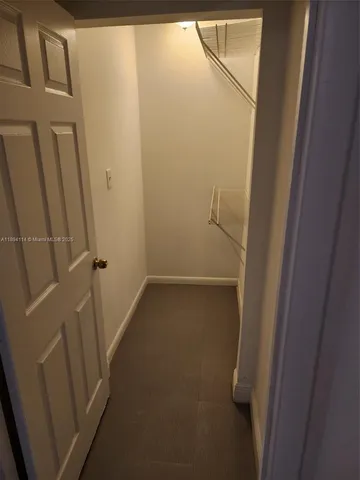 an empty room with a ceiling fan and window