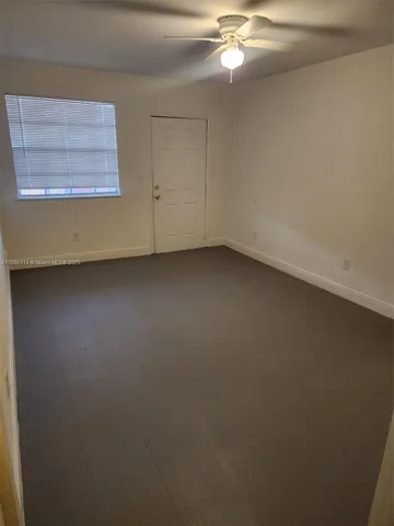 a view of a house with wooden fence