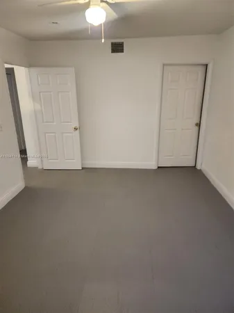 a view of a wooden fence with a flower garden