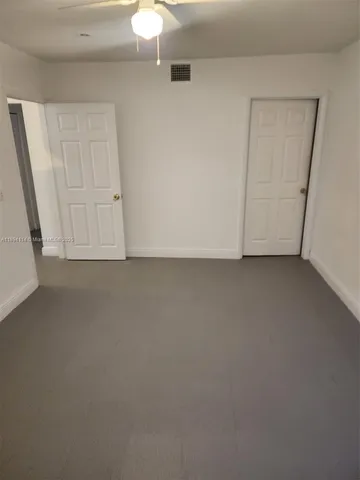 a view of a wooden fence with a flower garden