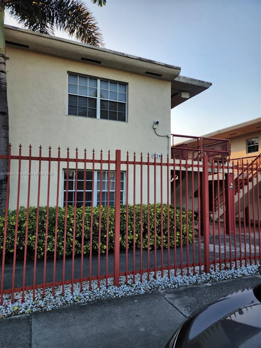 14240 Northwest 22nd Avenue, Unit 3 Opa-Locka, FL 33054 - Photo 27 of 49 a view of a house with wooden fence
