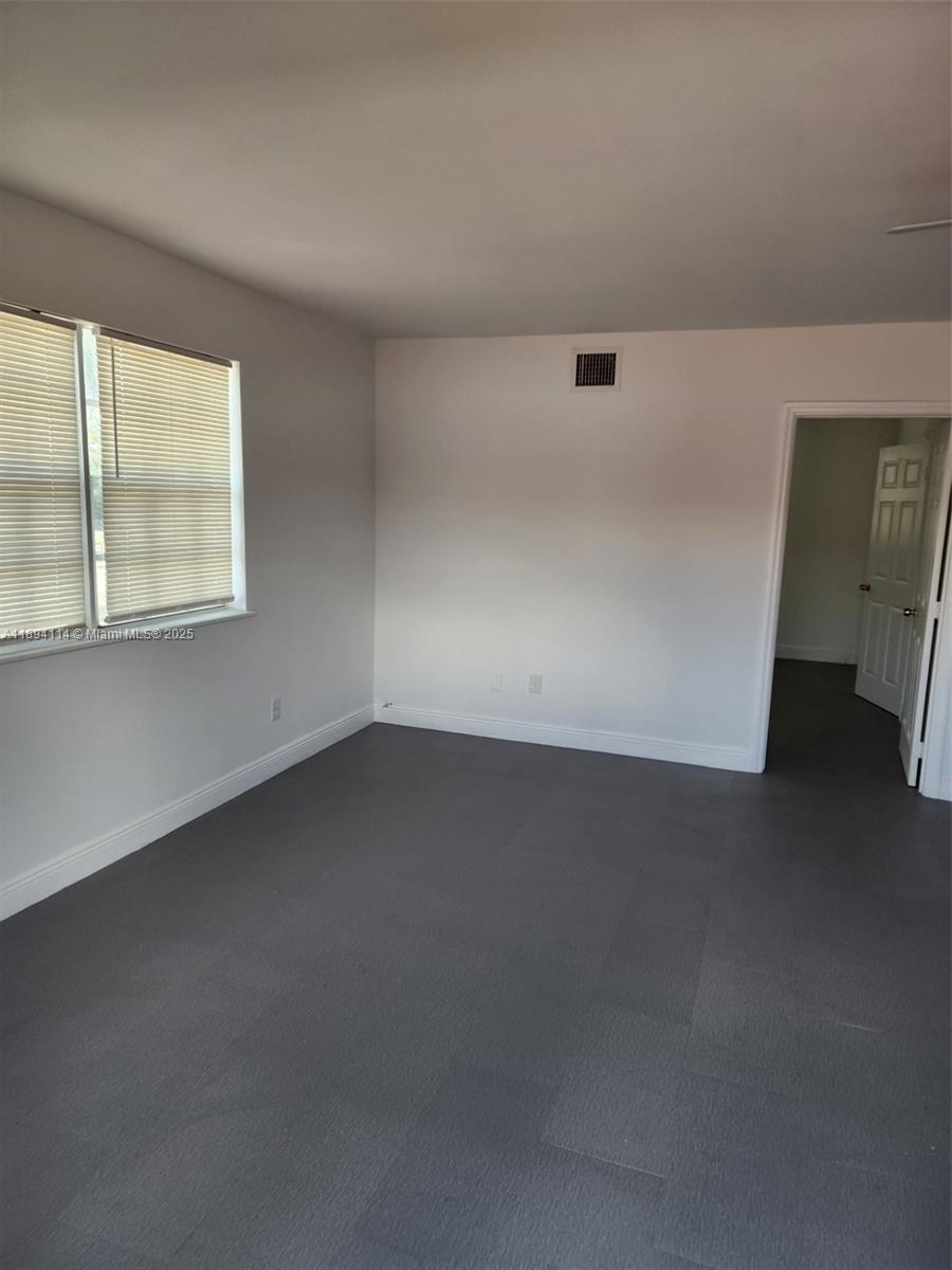 14240 Northwest 22nd Avenue, Unit 3 Opa-Locka, FL 33054 - Photo 30 of 49 an empty room with a window