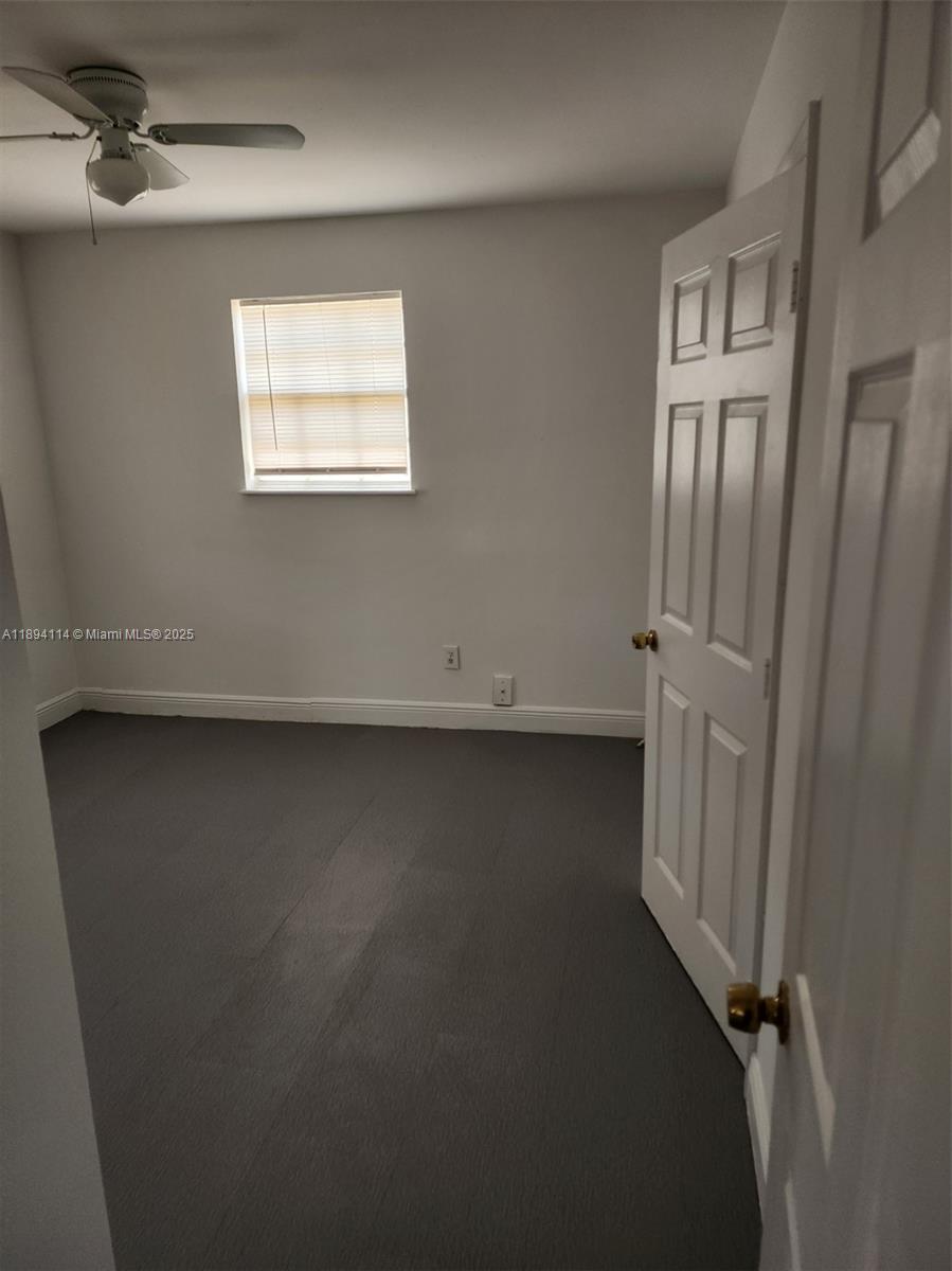 14240 Northwest 22nd Avenue, Unit 3 Opa-Locka, FL 33054 - Photo 32 of 49 an empty room with windows