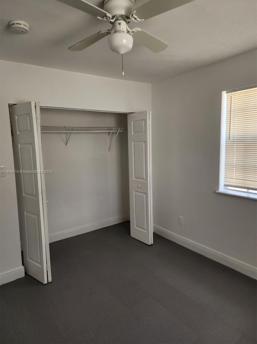 14240 Northwest 22nd Avenue, Unit 3 Opa-Locka, FL 33054 - Photo 33 of 49 an empty room with a ceiling fan and a window