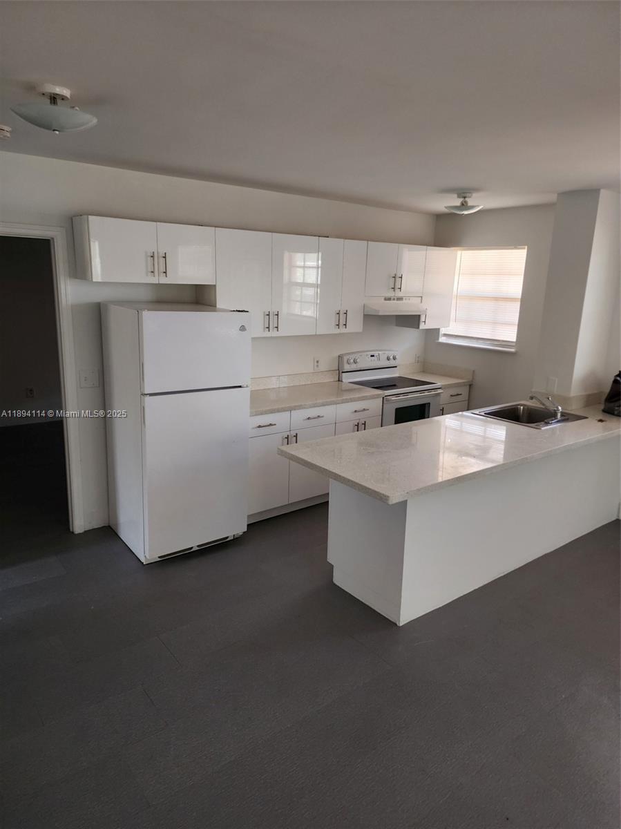 14240 Northwest 22nd Avenue, Unit 3 Opa-Locka, FL 33054 - Photo 44 of 49 a kitchen with appliances cabinets and a sink