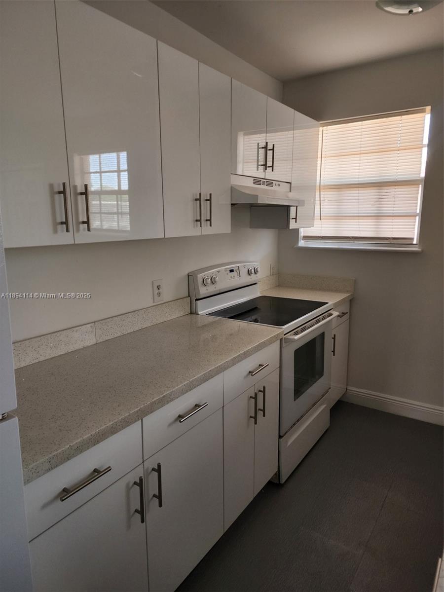 14240 Northwest 22nd Avenue, Unit 3 Opa-Locka, FL 33054 - Photo 47 of 49 a kitchen with appliances cabinets and a window