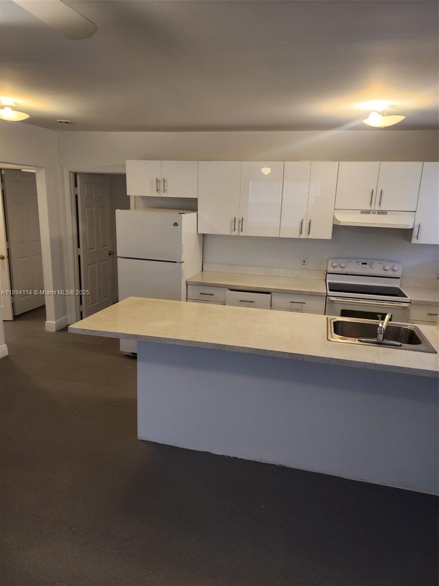 14240 Northwest 22nd Avenue, Unit 3 Opa-Locka, FL 33054 - Photo 5 of 49 a kitchen with stainless steel appliances a cabinets and stove top oven