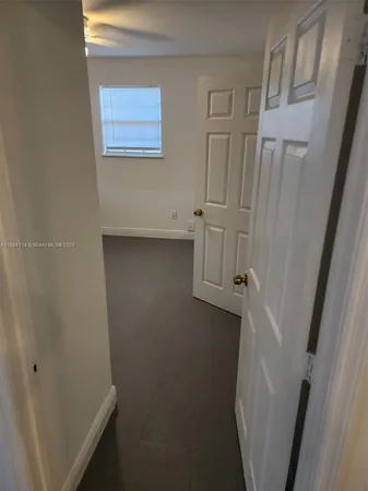 a view of storage and utility room with a refrigerator