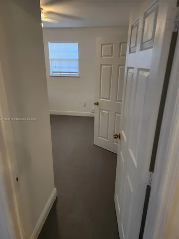 a view of storage and utility room with a refrigerator