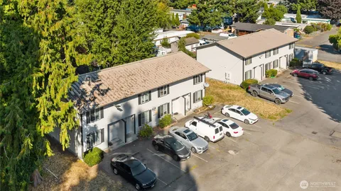 an aerial view of a house with garden space and street view